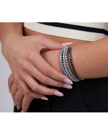 PULSERA ACERO DORADO MODELO RIVIER ELÁSTICA CON PIEDRAS COLOR TOPACIO AZUL DE CRISTAL